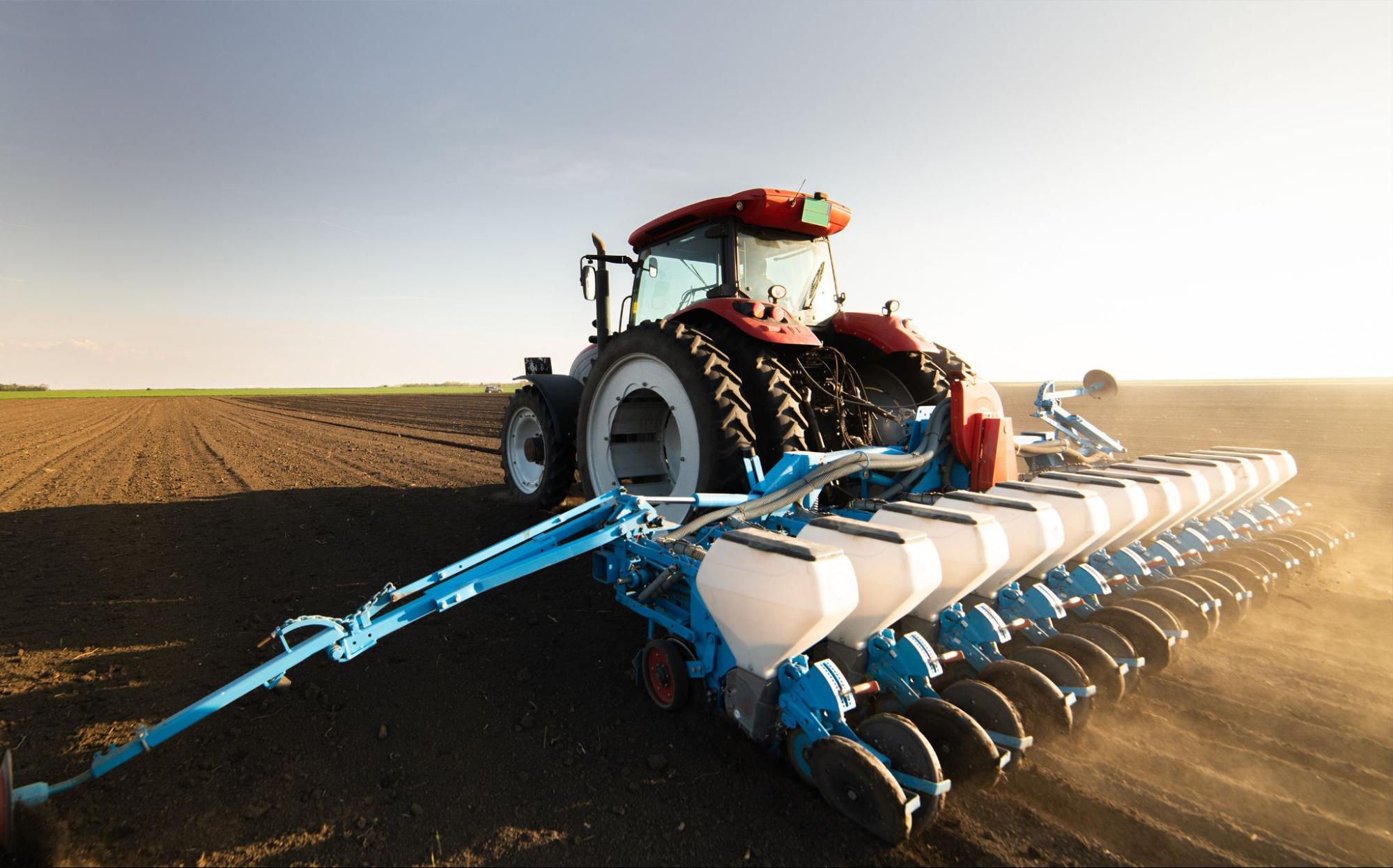 Photo of a tractor at work in a bare field