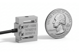 Micro S beam load cell shown next to a U.S. quarter for size comparison