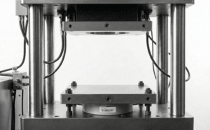 Compression load cell installed in a hydraulic press measuring applied force between platens