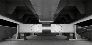 Double ended shear beam load cell installed beneath a truck scale platform