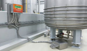 Industrial tank weighing system with explosion proof junction box and load cell wiring in hazardous environment