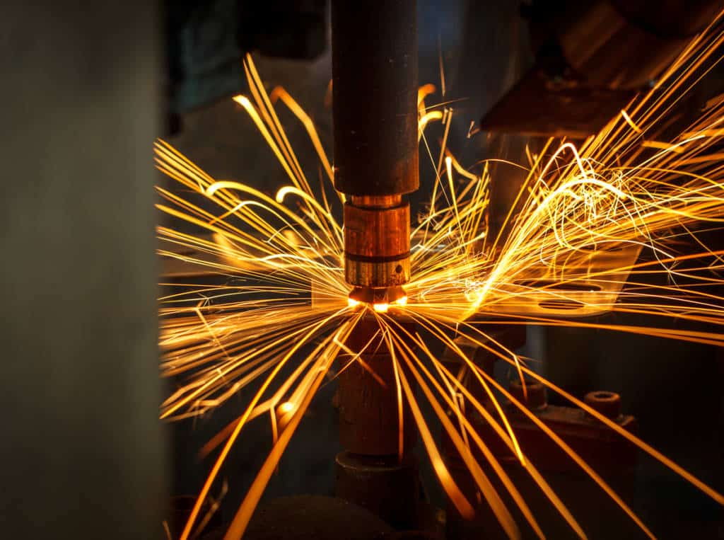 Motion Welding robots in a car factory with sparks, manufacturing, industry, factory