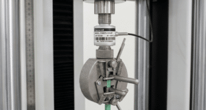 Inline threaded load cell mounted between actuator and fixture in a materials testing system