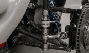 Inline threaded load cell installed in a race car suspension system measuring real-time force loads